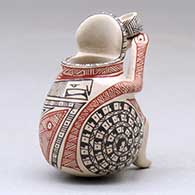 A miniature polychrome matachine holding a cup and decorated with a fineline and geometric design, click or tap to see a larger version