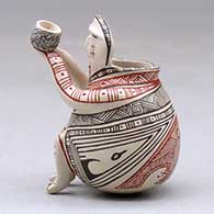 A miniature polychrome matachine holding a cup and decorated with a fineline and geometric design, click or tap to see a larger version