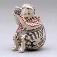 A miniature polychrome matachine holding a cup and decorated with a fineline and geometric design, click or tap to see a larger version