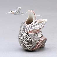 A miniature polychrome matachine figure decorated with a fineline geometric design and with a hummingbird hovering nearby, click or tap to see a larger version