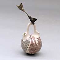 A miniature polychrome wedding vase decorated with a fineline and geometric design with a pair of hummingbirds hovering above the bridge
 by Carla Martinez of Mata Ortiz and Casas Grandes