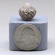 Miniature black-on-white seed pot with a four-panel fine line and geometric design, click or tap to see a larger version