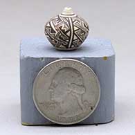 Miniature black-on-white seed pot with a four-panel fine line and geometric design, click or tap to see a larger version