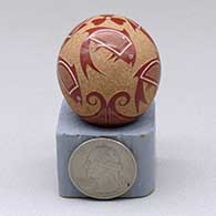 A miniature polychrome seed pot decorated with a three-panel sgraffito and painted fish and geometric design
 by Joseph Lonewolf of Santa Clara
