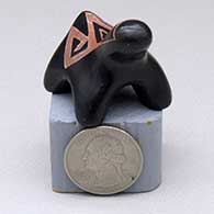 A miniature black bear figure with a sgraffito geometric design on its back
 by Linda Tafoya of Santa Clara