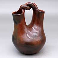 A brown wedding vase with a twisted bridge and fire clouds
 by Michelle Williams of Dineh