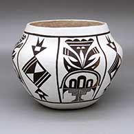 A black-on-white jar decorated with an eight-panel geometric design
 by Delores Sanchez of Acoma