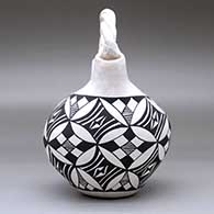 A black-on-white wedding vase with a twisted bridge and decorated with a pumpkin seed snowflake and geometric design, click or tap to see a larger version