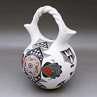 A polychrome wedding vase with a twisted bridge and decorated with a four-panel ancient Mogollon geometric design
 by Rachel Aragon of Acoma