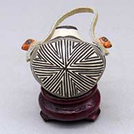 A polychrome miniature canteen with bird head handles and a fine line and geometric design
 by Wanda Aragon of Acoma