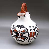 A polychrome wedding vase with a twisted bridge and decorated with a four-panel geometric design, click or tap to see a larger version