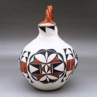 A polychrome wedding vase with a twisted bridge and decorated with a four-panel geometric design, click or tap to see a larger version