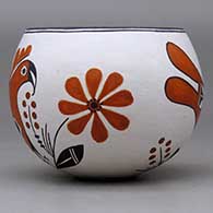 A polychrome bowl decorated with a parrot, flower, plant and geometric design, click or tap to see a larger version