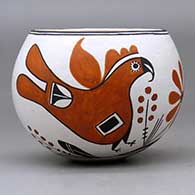 A polychrome bowl decorated with a parrot, flower, plant and geometric design, click or tap to see a larger version