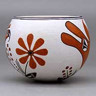 A polychrome bowl decorated with a parrot, flower, plant and geometric design, click or tap to see a larger version