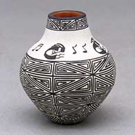 A miniature black on white jar decorated with a fineline, kokopelli and geometric design
 by Wanda Aragon of Acoma