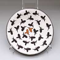 A shallow polychrome bowl decorated inside with Mimbres insect designs
 by Dolores Lewis of Acoma
