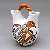A small polychrome wedding vase with a twisted bridge and decorated with a two panel bird element, fineline and geometric design
 by Marie S Juanico of Acoma