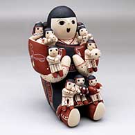 A sitting grandmother storyteller with 13 tiny children
 by Vangie Suina of Cochiti