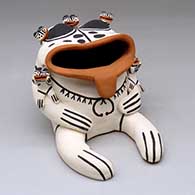 A polychrome frog storyteller figure with five small frogs
 by Rose Brown of Cochiti