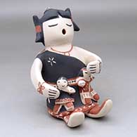 A sitting grandmother storyteller figure with two children
 by Snowflake Flower of Cochiti