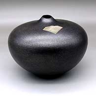 A micaceous black seed pot with an inlaid sterling silver Shifting Sands design and an organic opening
 by Preston Duwyenie of Hopi