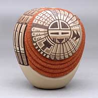 A polychrome seed pot decorated with a carved and painted katsina, sunface, ear of corn and geometric design, click or tap to see a larger version