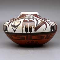 A low shouldered polychrome jar decorated with a four-panel bird element and geometric design above the shoulder and an eight-panel geometric design below the shoulder, click or tap to see a larger version