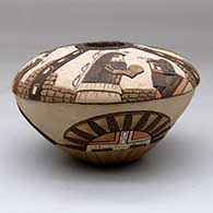 A polychrome seed pot decorated with a lightly carved, sgraffito and painted kachina, stone wall, bird element and geometric design, click or tap to see a larger version