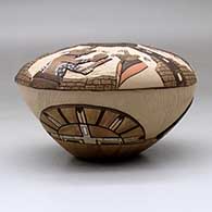 A polychrome seed pot decorated with a lightly carved, sgraffito and painted kachina, stone wall, bird element and geometric design, click or tap to see a larger version