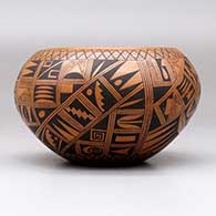 A black on red bowl polished inside and decorated on the outside with a small sherd and geometric design, click or tap to see a larger version