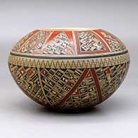 A polychrome bowl, polished inside and decorated on the outside with a small sherd and geometric design, click or tap to see a larger version