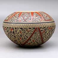 A polychrome bowl, polished inside and decorated on the outside with a small sherd and geometric design, click or tap to see a larger version