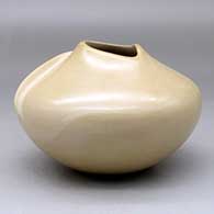 A buff bowl with an organic opening and a carved ear-of-corn applique, click or tap to see a larger version
