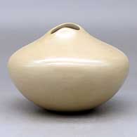 A buff bowl with an organic opening and a carved ear-of-corn applique, click or tap to see a larger version