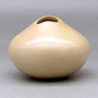 A buff jar with an organic opening and a carved ear of corn applique, click or tap to see a larger version