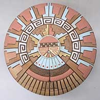 A polychrome seed pot decorated with a carved, sgraffito and painted katsina, feather, kiva step and geometric design
 by Thomas Polacca of Hopi