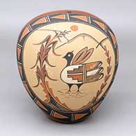 A polychrome seed pot decorated on one side with a painted bird, cornstalk and geometric design
 by Virginia Ponca Fragua of Jemez