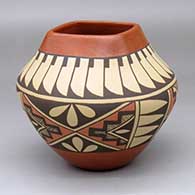A polychrome bowl with a squarish opening and decorated with a four-panel feather, kiva step, cloud and geometric design
 by Juanita Fragua of Jemez