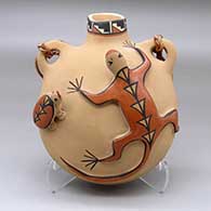 A polychrome canteen with with handles and a turtle and a lizard applique on the front
 by Marie G Romero of Jemez
