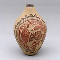A polychrome seed pot decorated with a sgraffito and painted flower, corn stalk, feather and geometric design
 by Glendora Fragua of Jemez