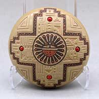 A miniature polychrome seed pot decorated with a lightly carved, sgraffito and painted sunface, feather, kiva step and geometric design, with four inlaid stones
 by Glendora Fragua of Jemez