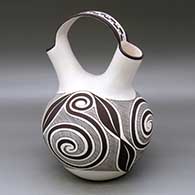 A black on white wedding vase decorated with a Tularosa spiral, fineline and geometric design
 by Myron Sarracino of Laguna