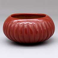A carved red melon bowl with 32 ribs
 by David Baca of Santa Clara