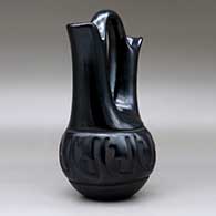 A black wedding vase carved around the body with a geometric design, click or tap to see a larger version