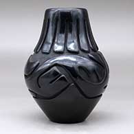 A black jar carved with an avanyu and ring of feathers design, click or tap to see a larger version