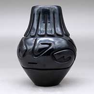 A black jar carved with an avanyu and ring of feathers design, click or tap to see a larger version