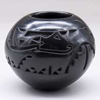 A small black jar carved around the body with an avanyu and kiva step design
 by Doris Tenorio of Santa Clara
