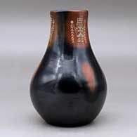 A black vase with sienna spots and a three panel sgraffito yeibichai and geometric design, click or tap to see a larger version