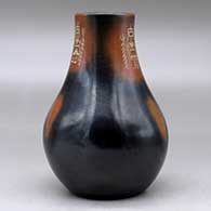 A black vase with sienna spots and a three panel sgraffito yeibichai and geometric design, click or tap to see a larger version